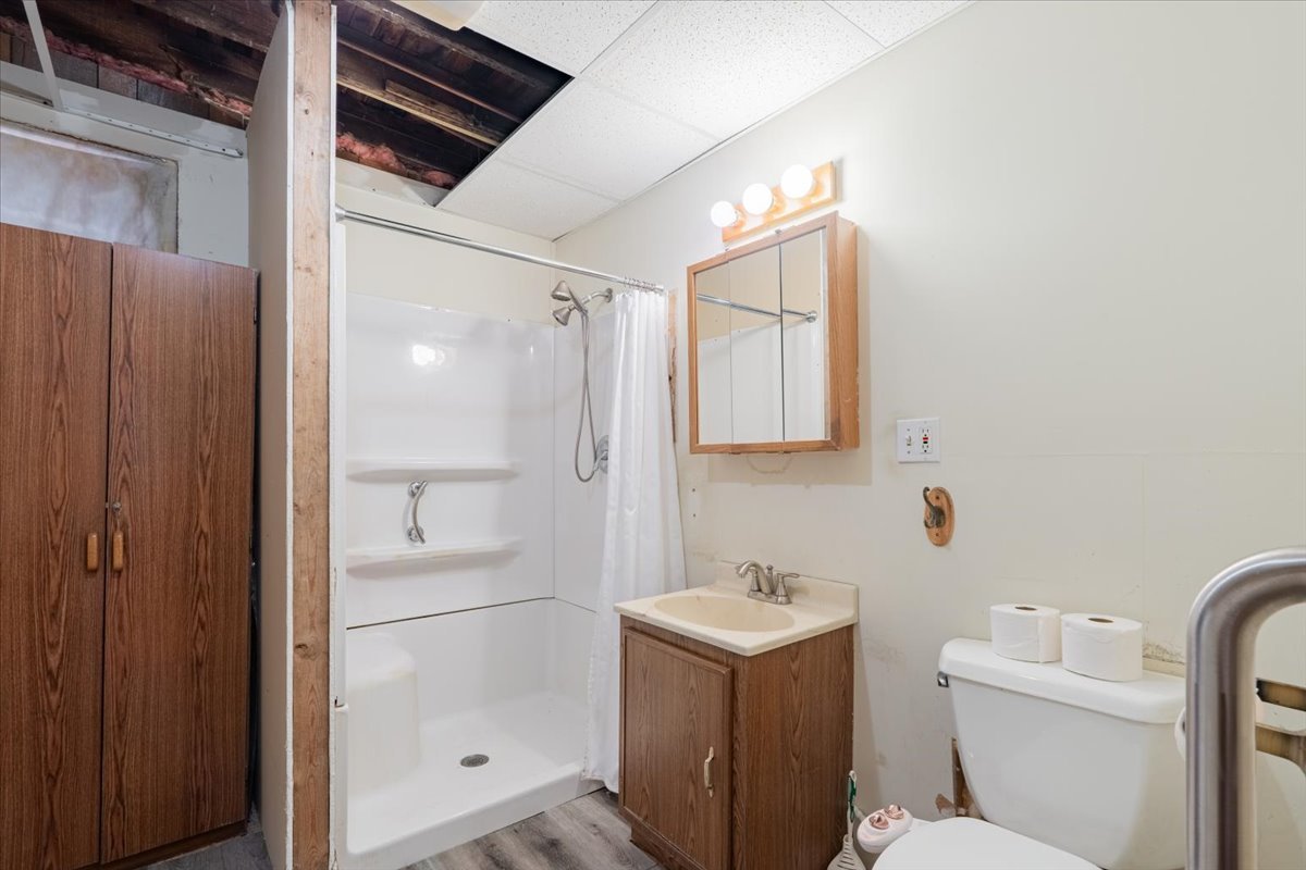 321 East 2nd Street El Paso, IL 61738 - Photo 16 of 37 a bathroom with a sink mirror vanity and toilet