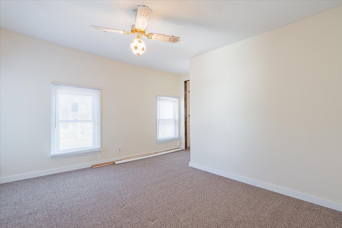 321 East 2nd Street El Paso, IL 61738 - Photo 20 of 37 an empty room with windows and chandelier fan
