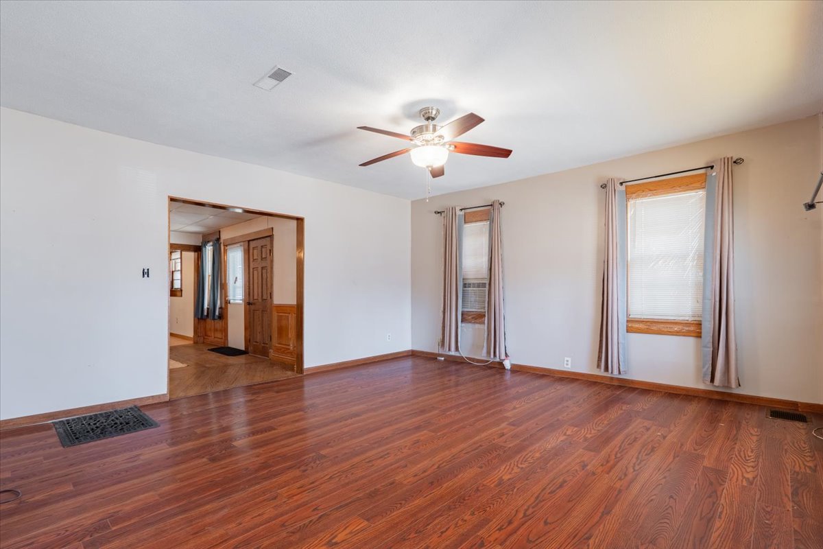 321 East 2nd Street El Paso, IL 61738 - Photo 6 of 37 a view of an empty room with window and wooden floor