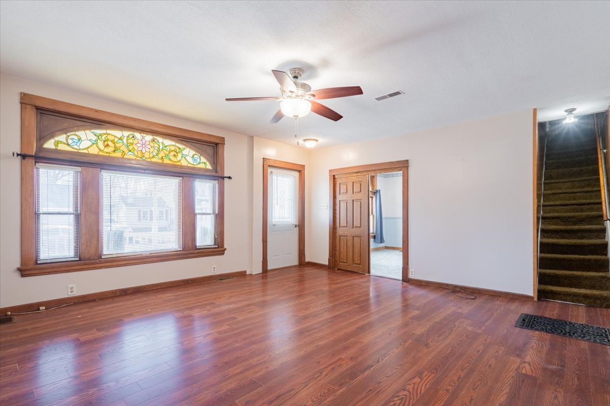 321 East 2nd Street El Paso, IL 61738 - Photo 7 of 37 a view of an empty room with a window and wooden floor