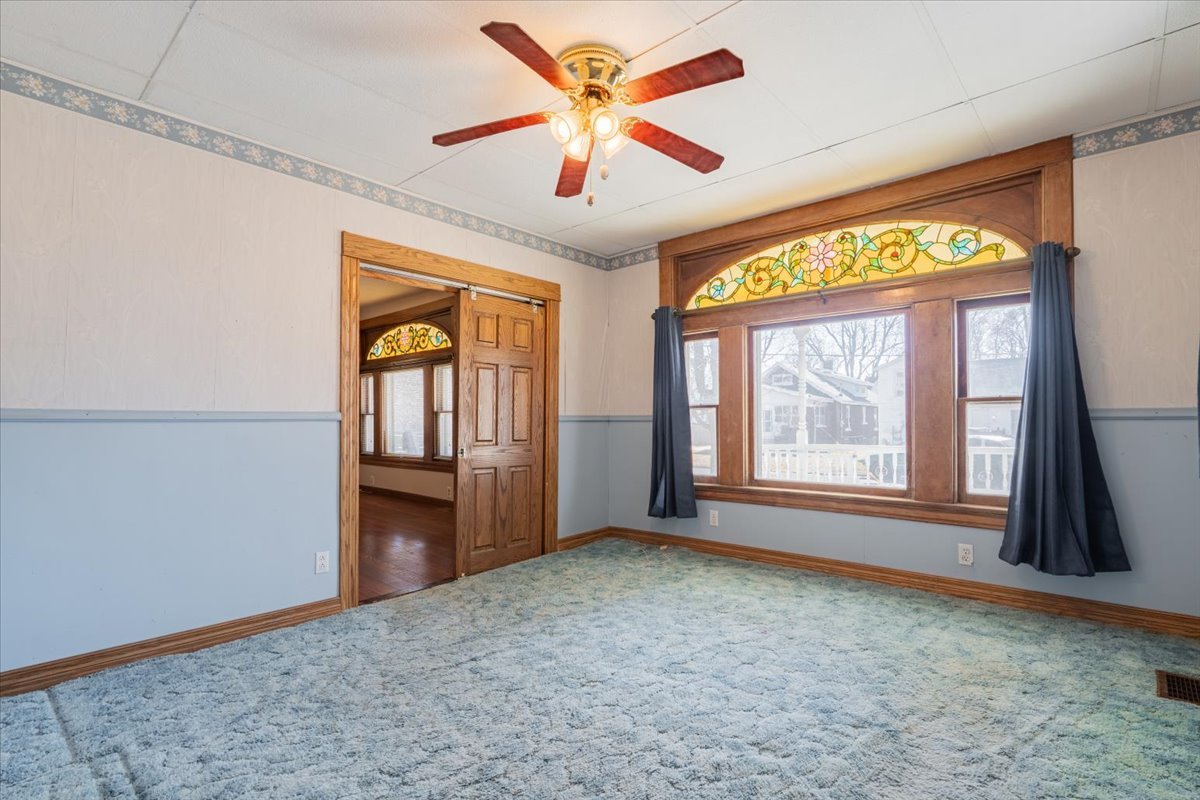 321 East 2nd Street El Paso, IL 61738 - Photo 8 of 37 an empty room with windows and fan