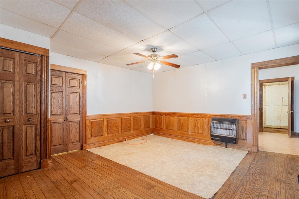 321 East 2nd Street El Paso, IL 61738 - Photo 10 of 37 wooden floor in an empty room with a window