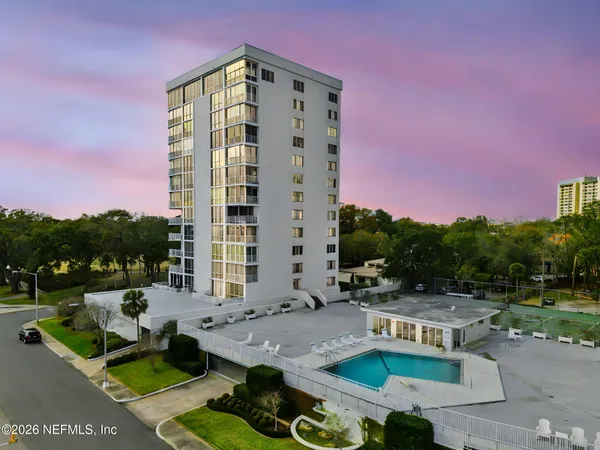 a front view of a house with swimming pool and a yard