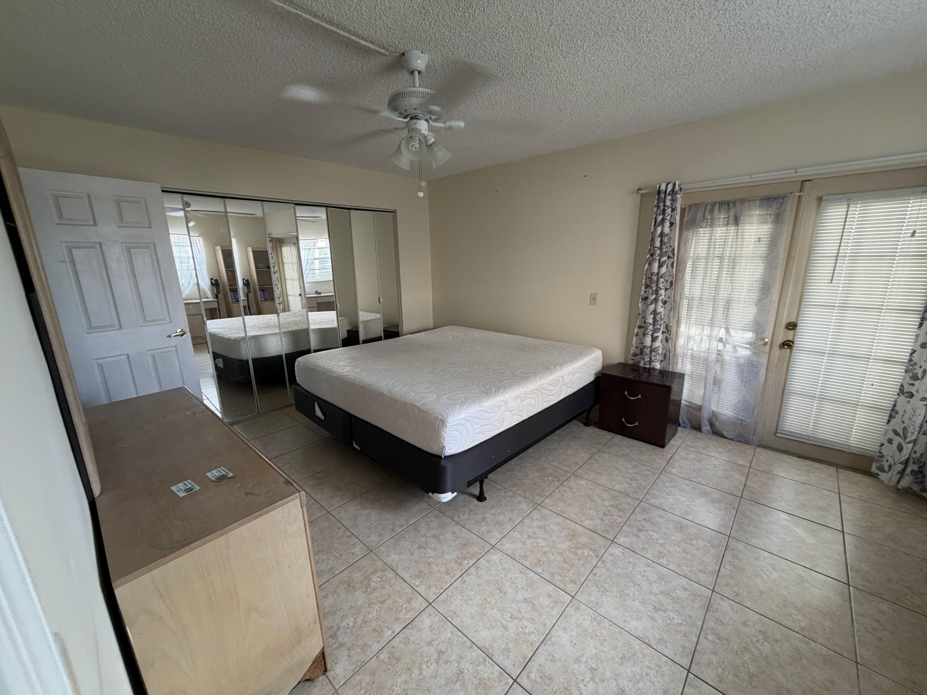 7 Flanders A Delray Beach, FL 33484 - Photo 2 of 4 a bed room with a bed and a couch