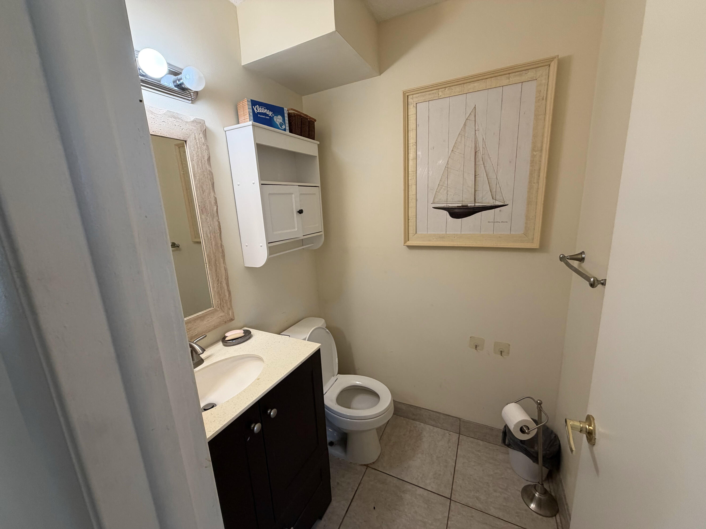 7 Flanders A Delray Beach, FL 33484 - Photo 4 of 4 a bathroom with a toilet sink and mirror