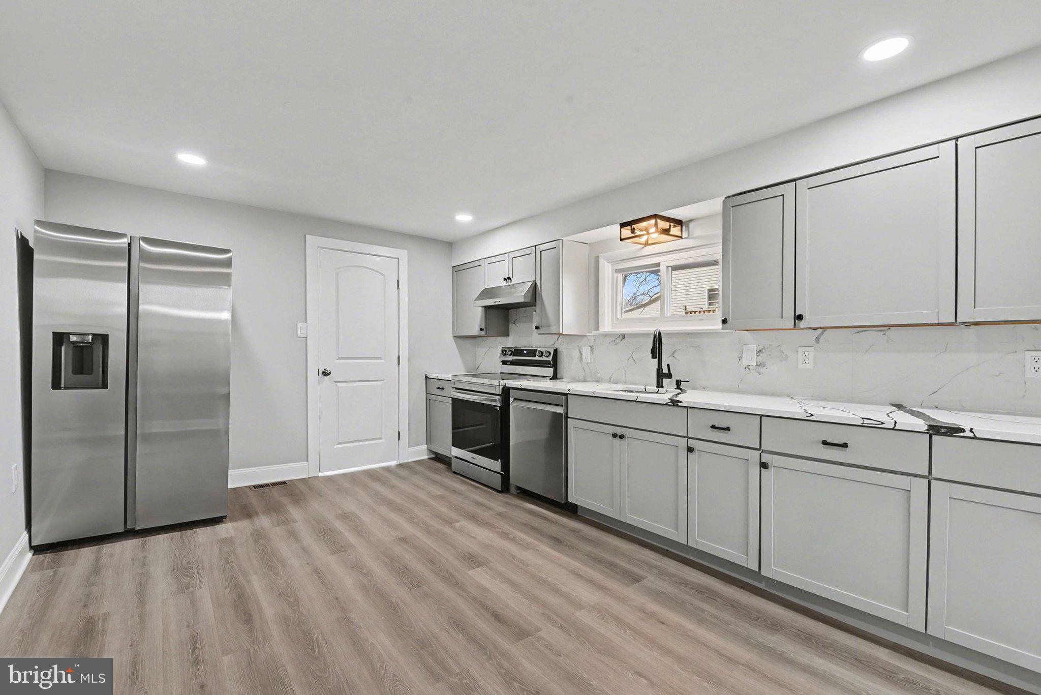 210 Beaver Road Harrisburg, PA 17112 - Photo 13 of 32 a kitchen with granite countertop a refrigerator sink and cabinets