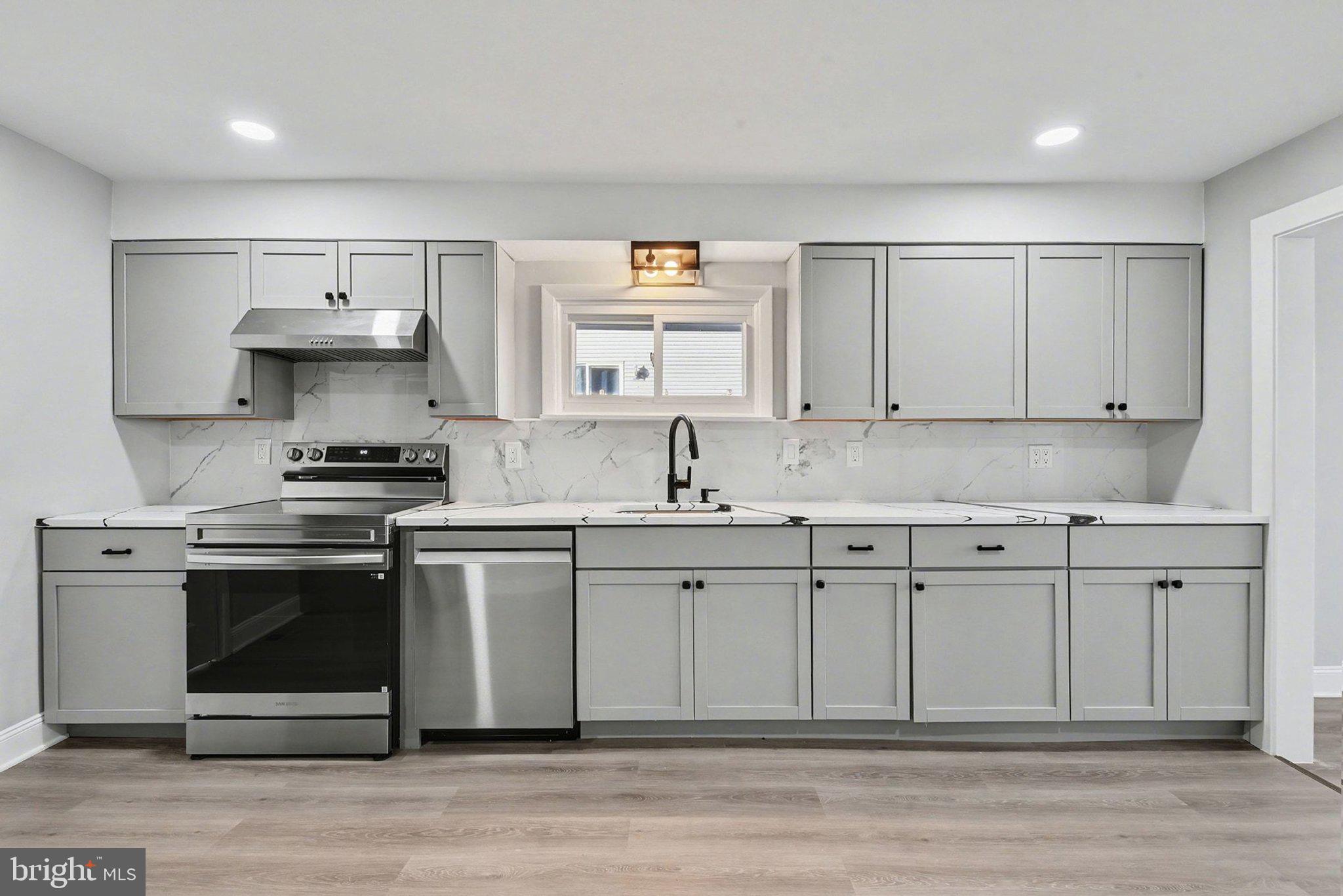 210 Beaver Road Harrisburg, PA 17112 - Photo 15 of 32 a kitchen with stainless steel appliances granite countertop a stove a sink and a microwave