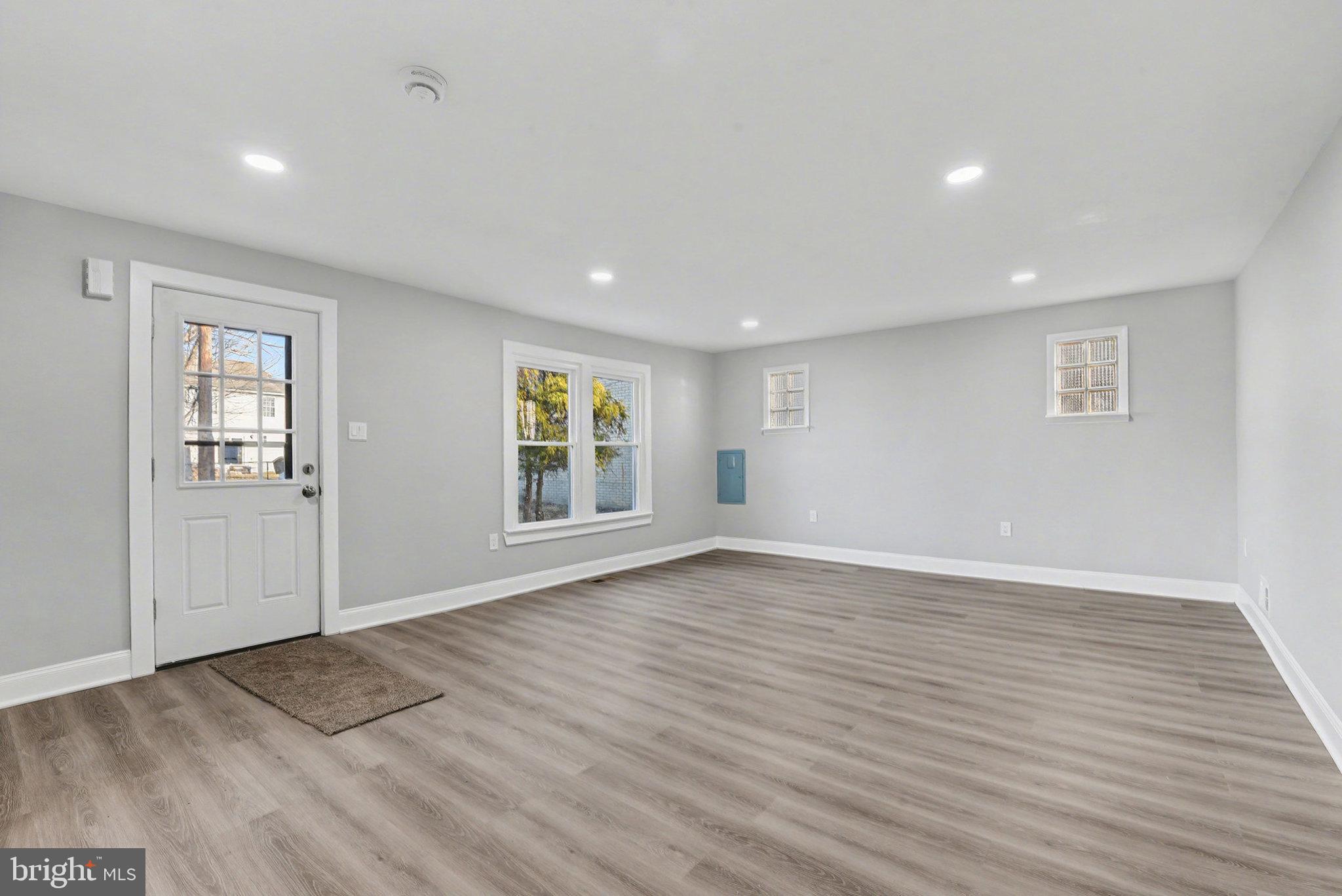 210 Beaver Road Harrisburg, PA 17112 - Photo 5 of 32 an empty room with wooden floor and windows