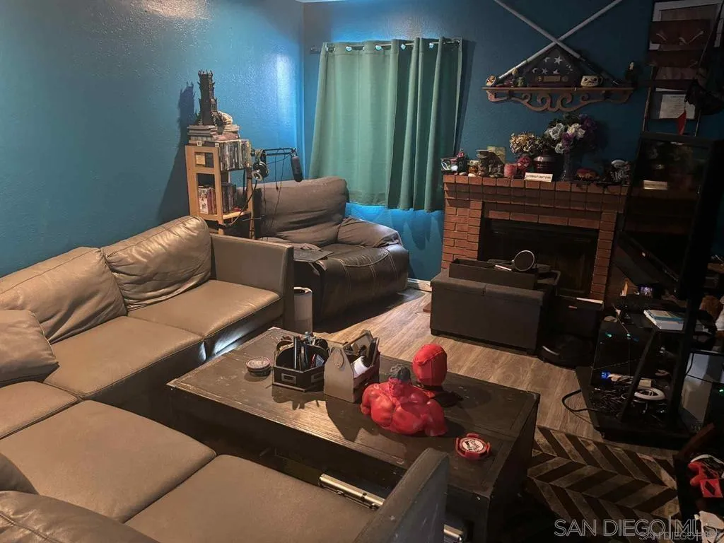 12741 Laurel Street, Unit 58 Lakeside, CA 92040 - Photo 5 of 12 a living room with furniture and a fireplace