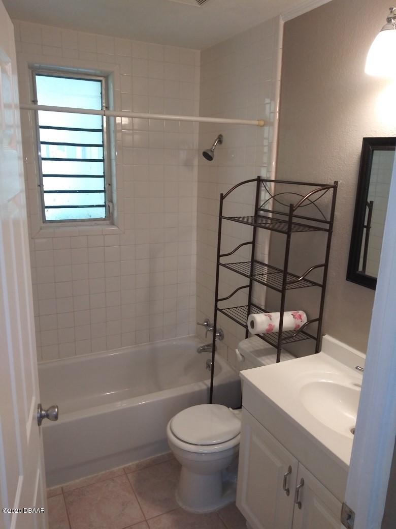 939 West Granada Boulevard Ormond Beach, FL 32174 - Photo 11 of 14 a bathroom with a toilet and a shower