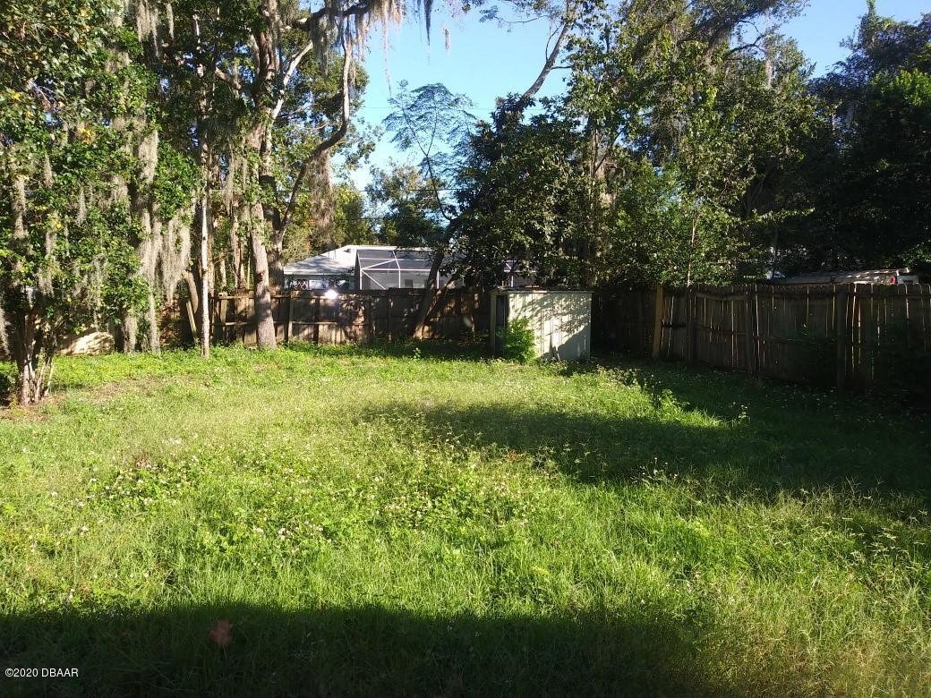 939 West Granada Boulevard Ormond Beach, FL 32174 - Photo 12 of 14 a backyard of a house with lots of green space
