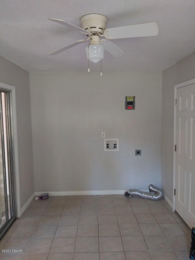939 West Granada Boulevard Ormond Beach, FL 32174 - Photo 3 of 14 wooden floor in an empty room with a window