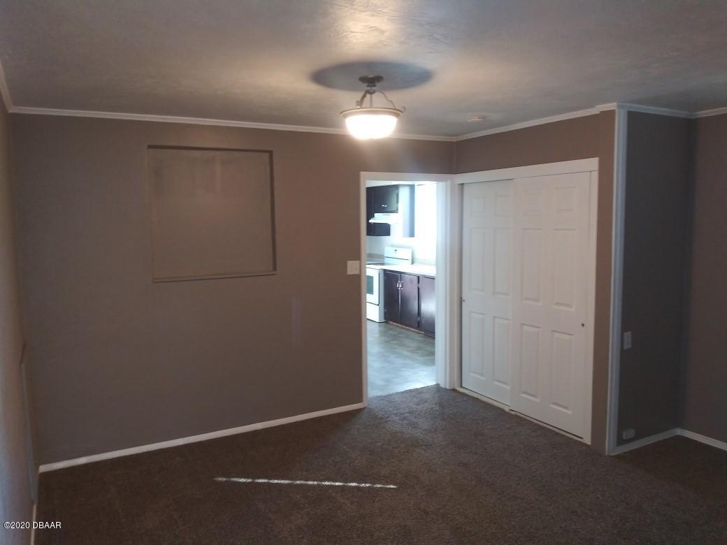 939 West Granada Boulevard Ormond Beach, FL 32174 - Photo 9 of 14 a view of a room with a ceiling fan and a window