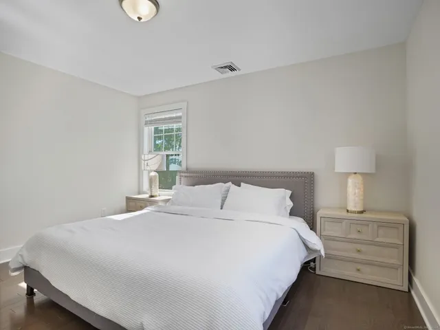 a bedroom with a bed and a lamp