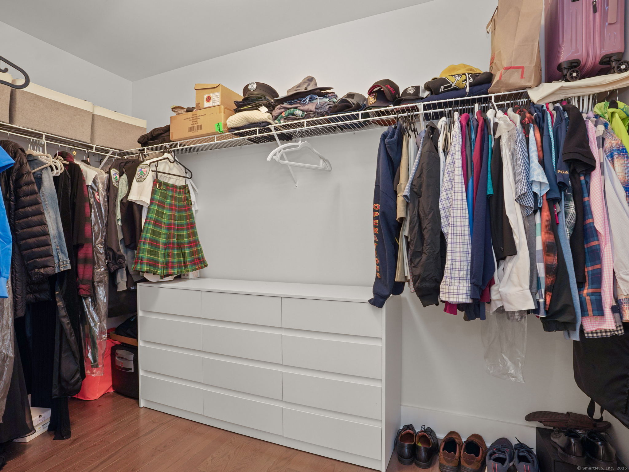 118 Berwick Avenue, Unit 118 Fairfield, CT 06825 - Photo 17 of 29 a view of walk in closet with clothes and shoes