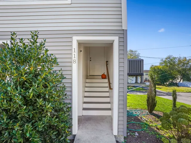 a view of a patio with table and chairs and potted plants