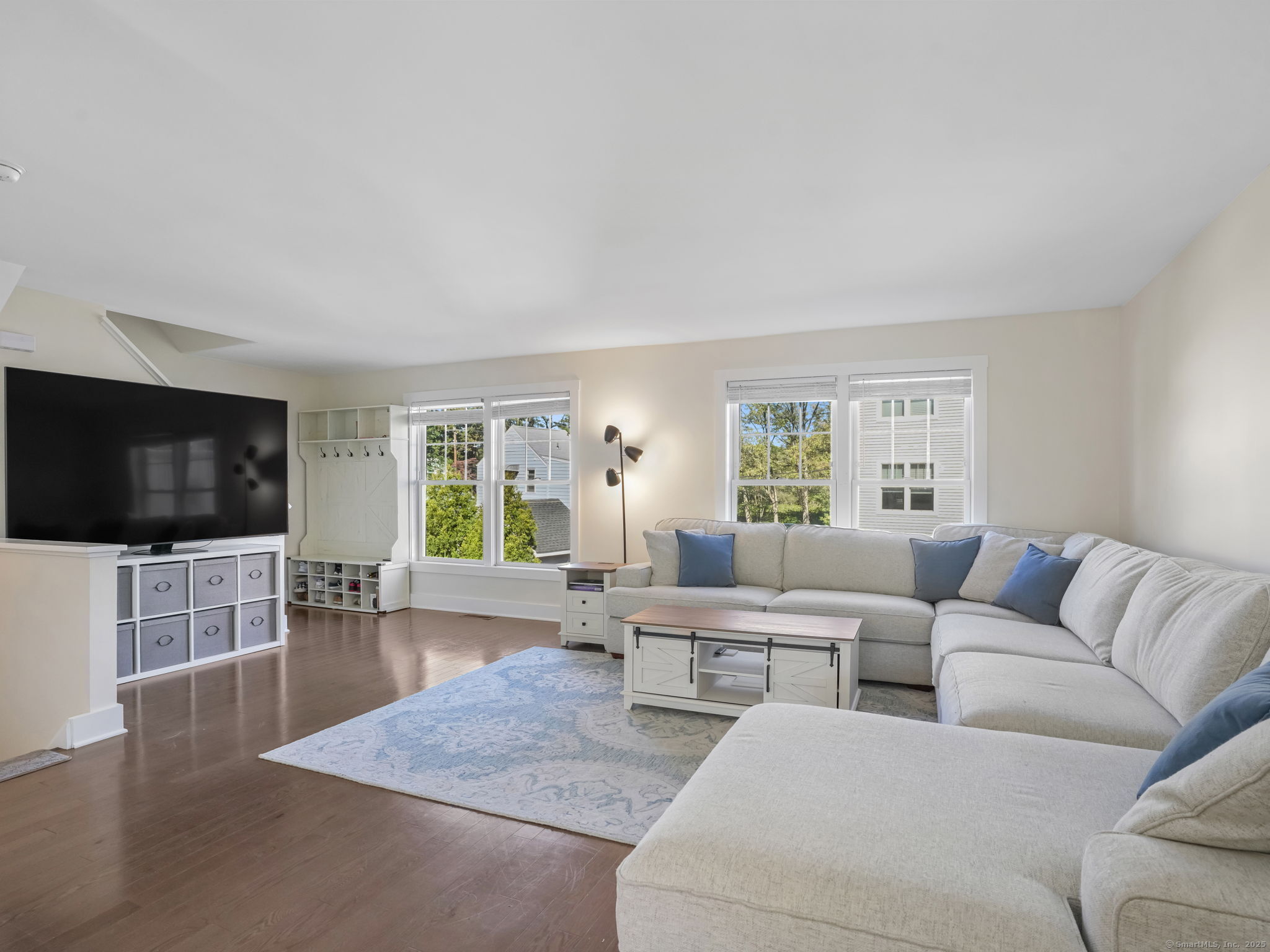 118 Berwick Avenue, Unit 118 Fairfield, CT 06825 - Photo 4 of 29 a living room with furniture and a flat screen tv