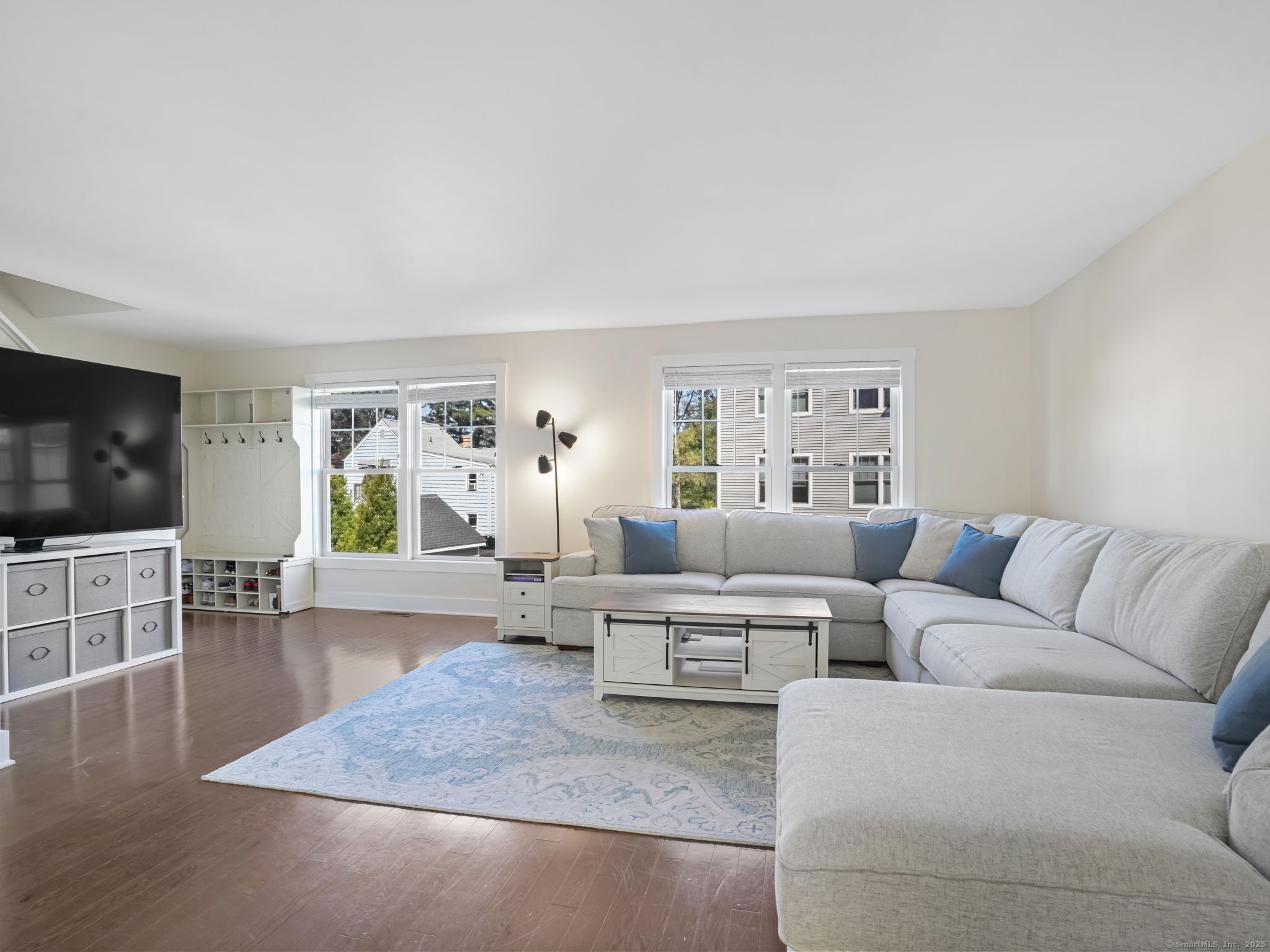 118 Berwick Avenue, Unit 118 Fairfield, CT 06825 - Photo 5 of 29 a living room with furniture wooden floor and a flat screen tv