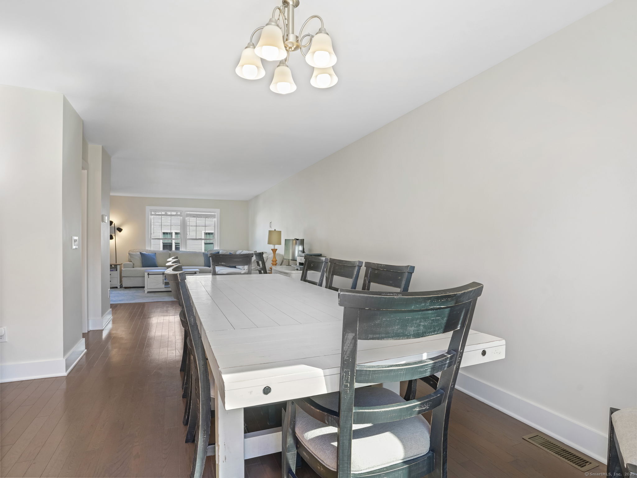 118 Berwick Avenue, Unit 118 Fairfield, CT 06825 - Photo 7 of 29 a view of a dining room with furniture and a chandelier