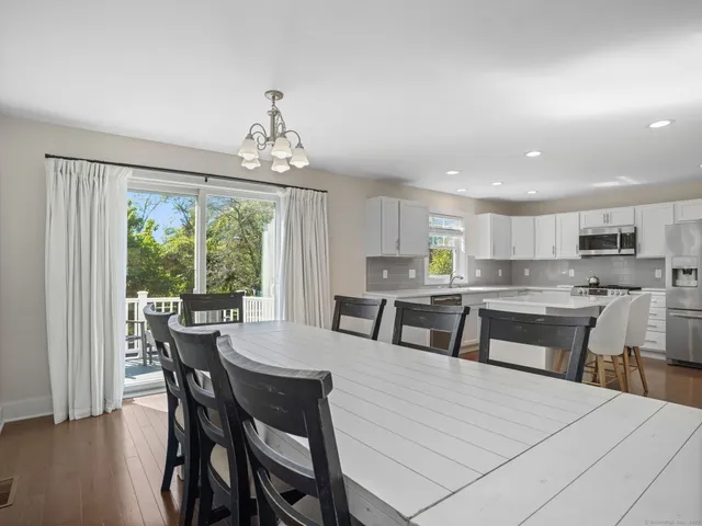 a large kitchen with a table and chairs