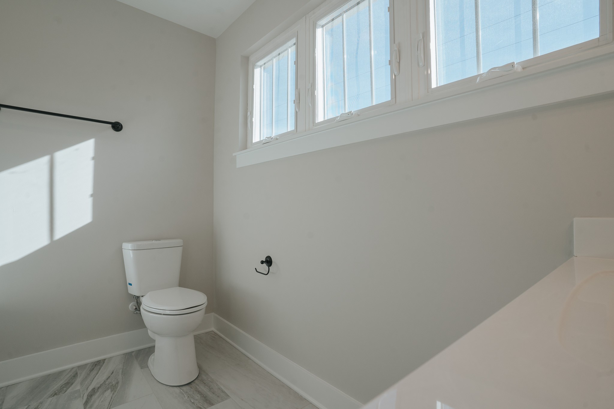 795 19th Avenue West Springfield, TN 37172 - Photo 18 of 26 a white toilet sitting next to a bathroom sink