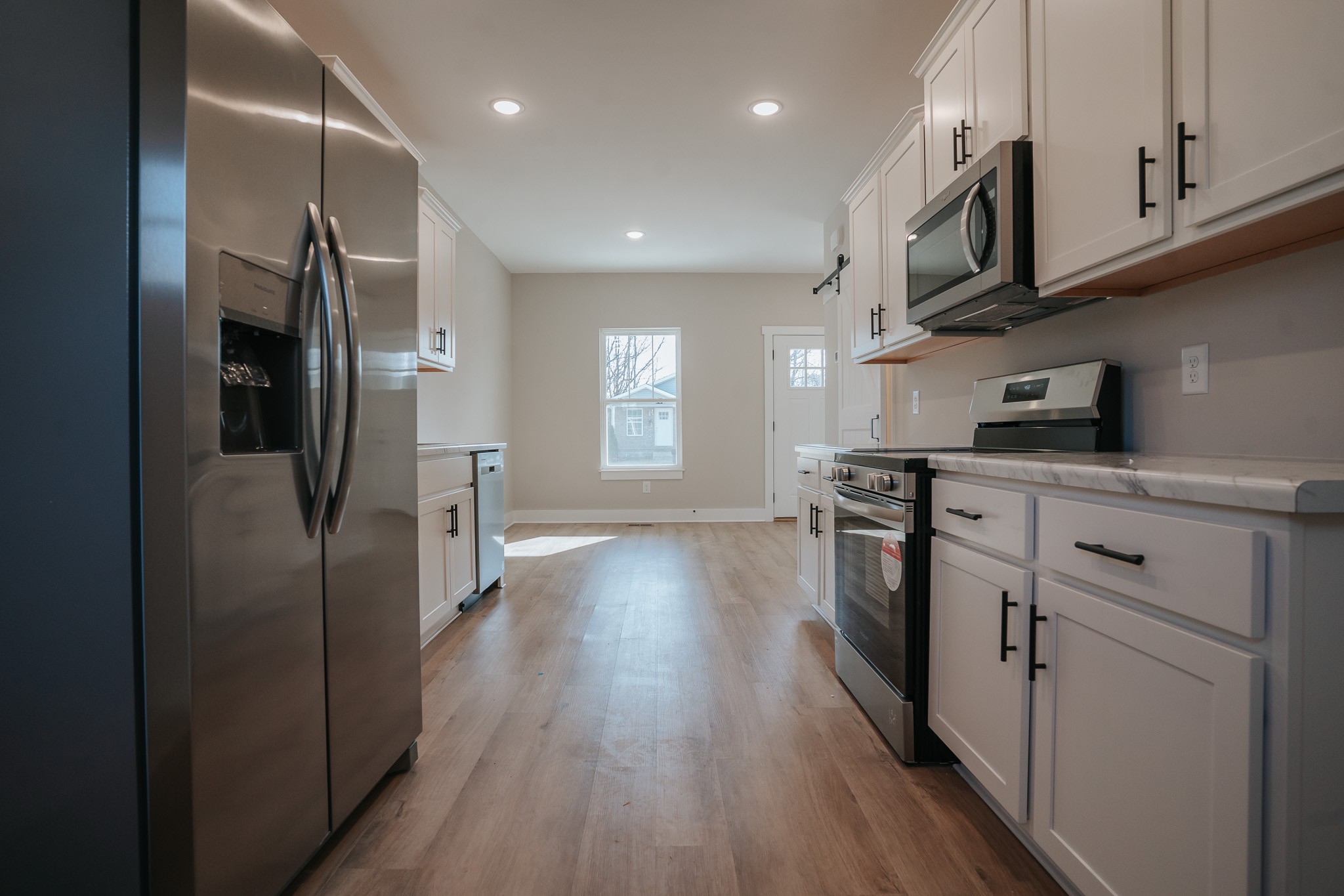 795 19th Avenue West Springfield, TN 37172 - Photo 8 of 26 a kitchen with stainless steel appliances granite countertop a refrigerator a stove and a wooden floors