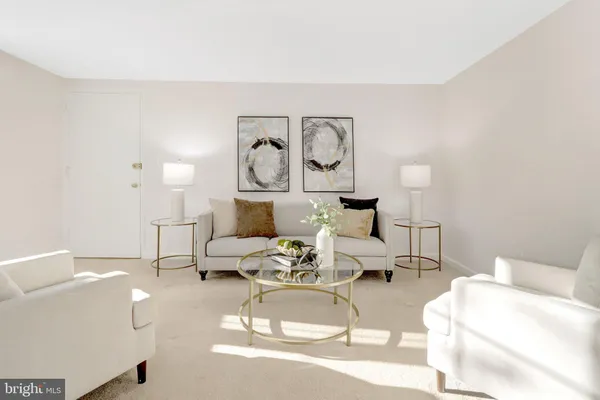 a living room with furniture and white walls