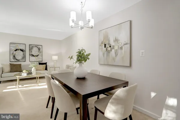 a view of a dining room with furniture and chandelier