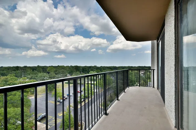 a balcony with trees in the back yard