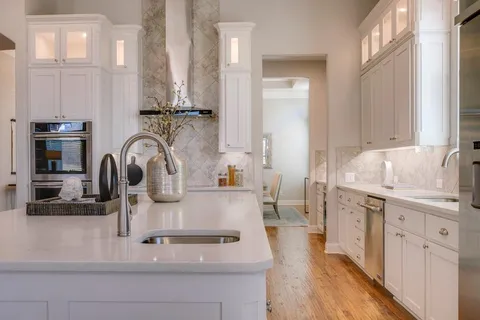 a kitchen with stainless steel appliances granite countertop a sink and cabinets