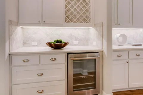 a kitchen with white cabinets and a stove