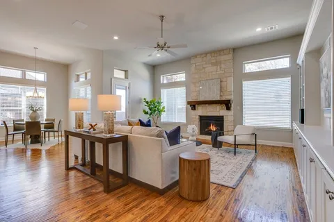 a living room with furniture a fireplace and a wooden floor