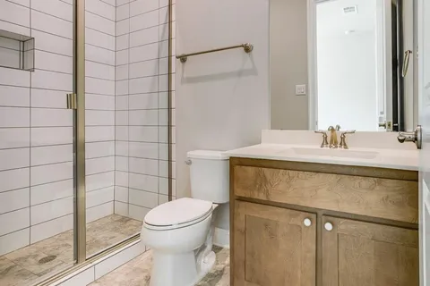 a bathroom with a sink toilet and shower