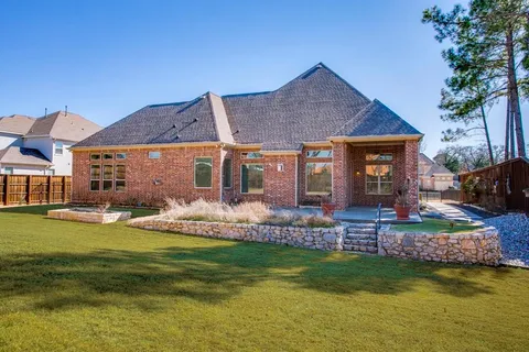 a front view of a house with a garden and swimming pool