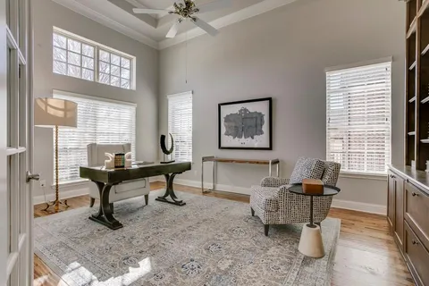 a view of a livingroom with workspace and a window