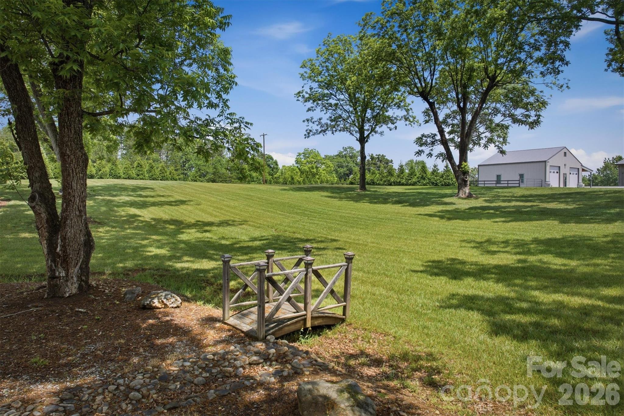 7490 Oak Ridge Church Road Connelly Springs, NC 28612 - Photo 34 of 44 a view of a field with sitting area and garden