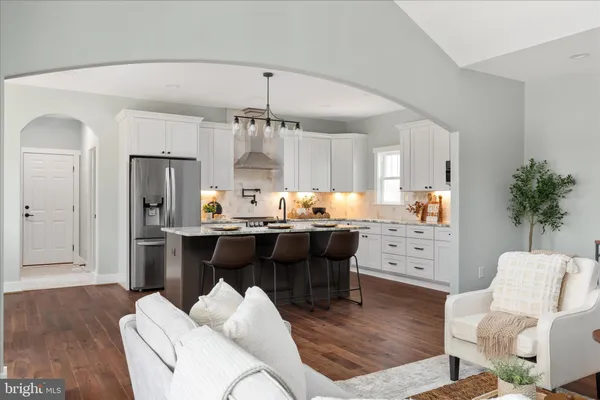 a kitchen with sink stove top oven and cabinets