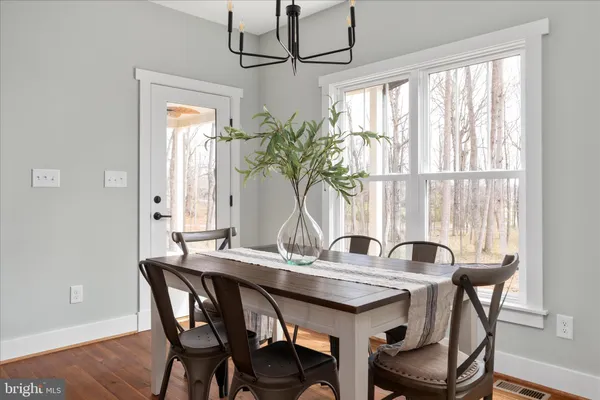 a kitchen with stainless steel appliances granite countertop a sink and wooden floor