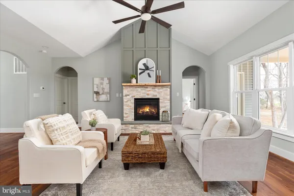 a kitchen with stainless steel appliances a dining table chairs and wooden floor