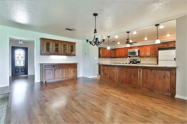 a open kitchen with a sink and dishwasher with a large kitchen island