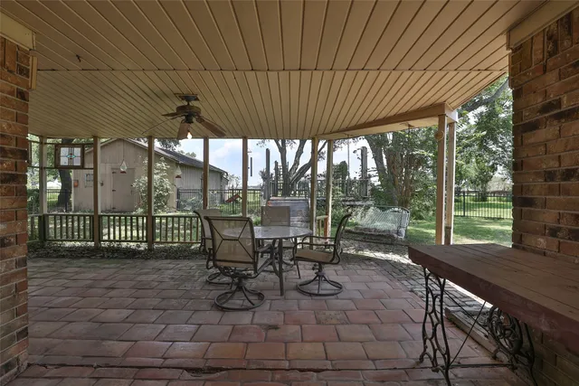 a view of a patio with a table chairs and a backyard