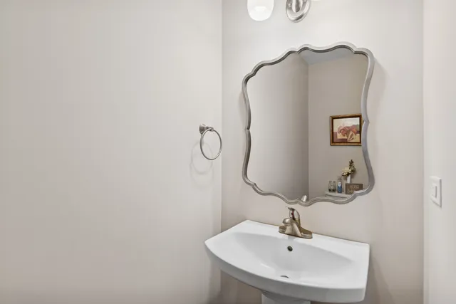 a bathroom with a sink and mirror
