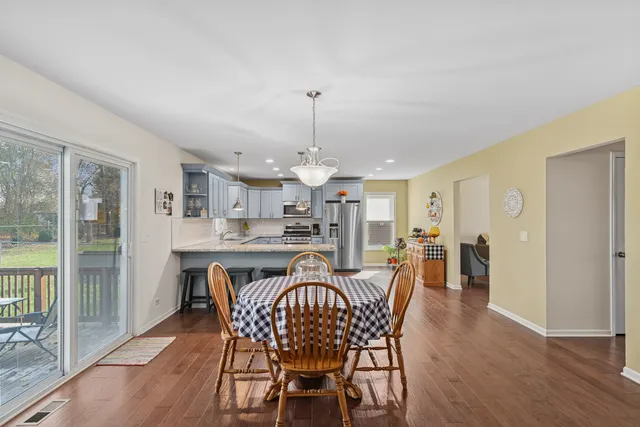 a dining room with furniture window and wooden floor