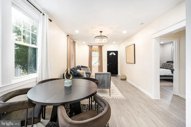 a living room with furniture a couch and a chandelier