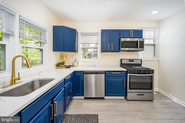 a view of a work space with wooden floor and a window