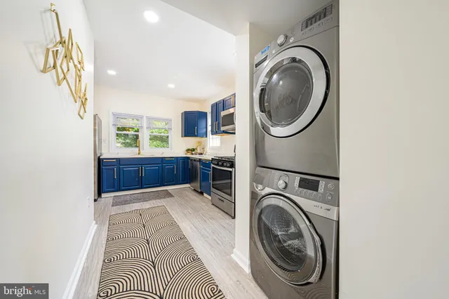 a view of a workspace with wooden floor and a window
