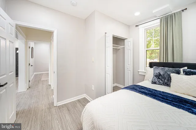 a bedroom with a bed and a window