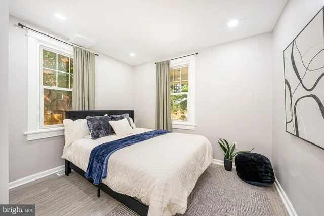 a bedroom with a bed and large window