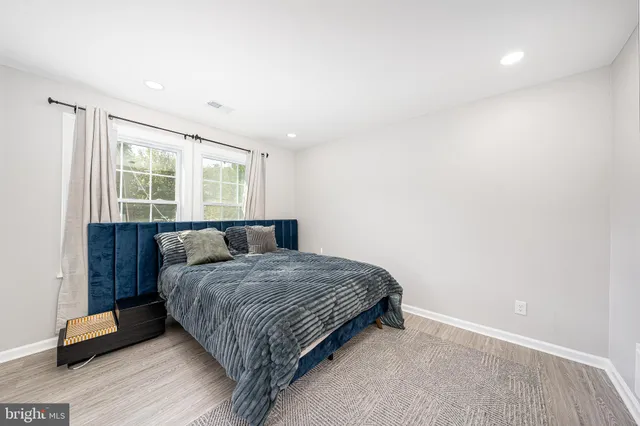 a bedroom with a large bed and a window