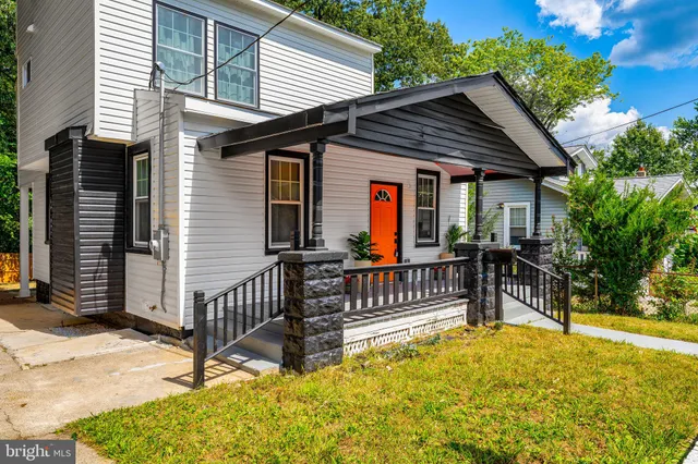 a view of house with a wooden fence and a floor to ceiling window